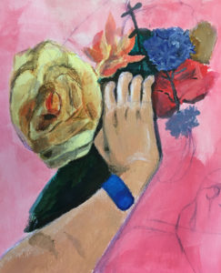 hand holding flowers with blue wrist band