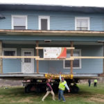 Owner and moving crew celebrate as Boardwalk House has arrived at its destination.